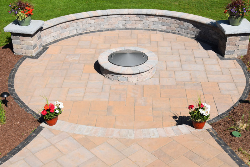 Paver patio with fire pit and wall
